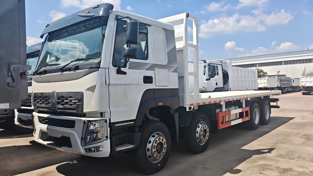 HOWO 8x4 Flatbed Truck supplier China heavy duty cargo truck with reinforced Q345B steel flatbed for heavy machinery transport